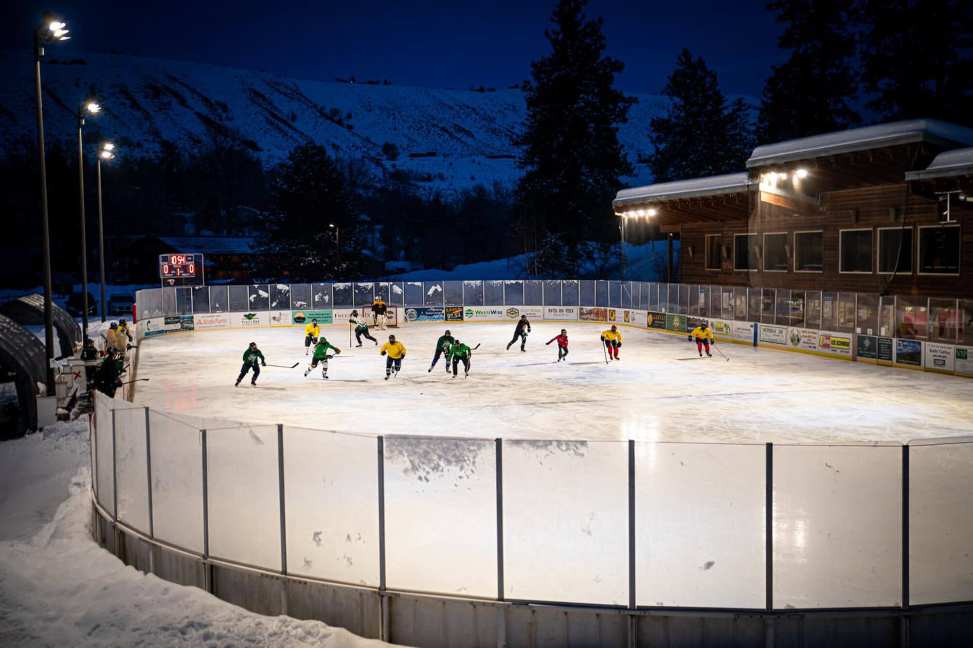 People play hocky on an outdoor ice rink
