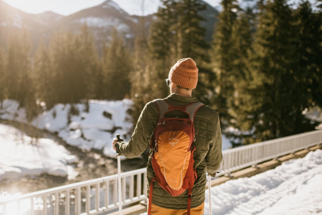A man enjoys snowshoeing in washington state overlooking a river