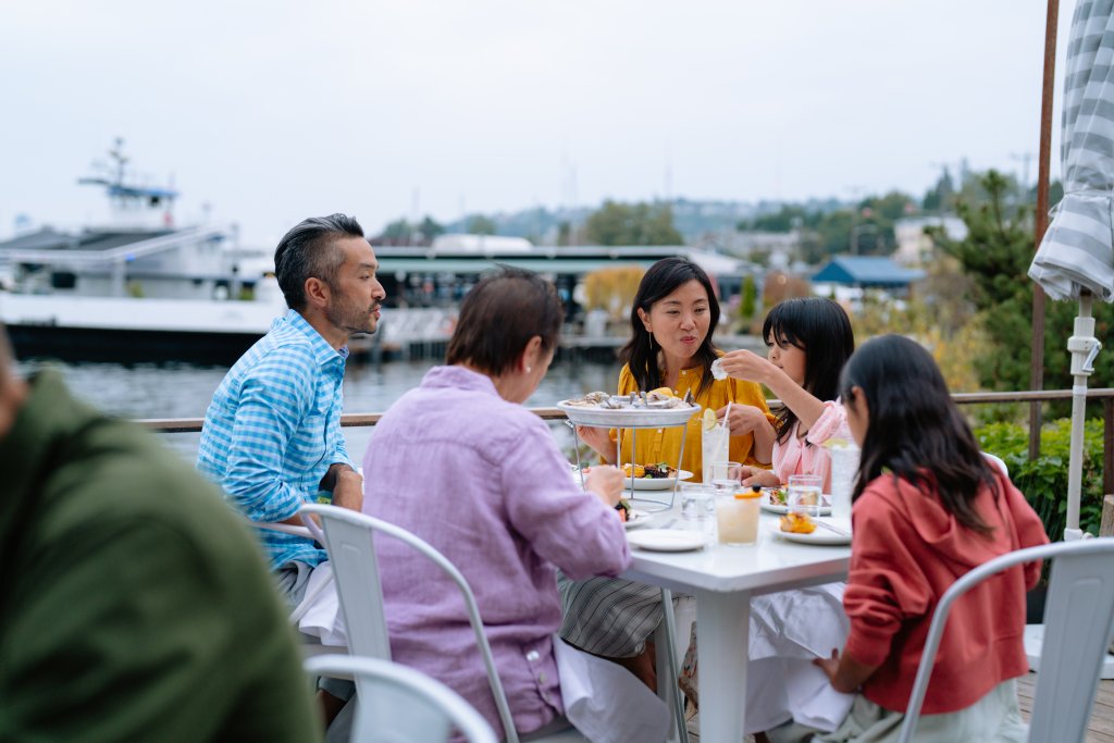 A family enjoys dinner together on the outside patio at Westward in Seattle.