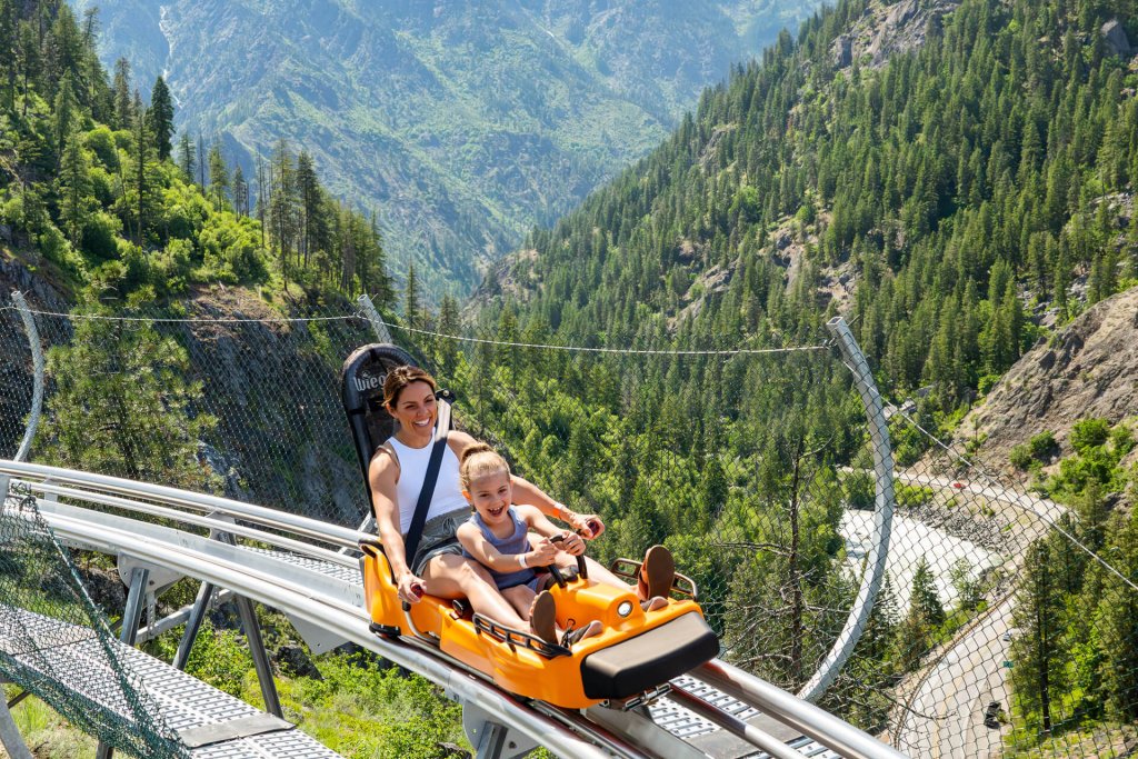 Photo of a woman and young girl riding an alpine roller coaster in Leavenworth