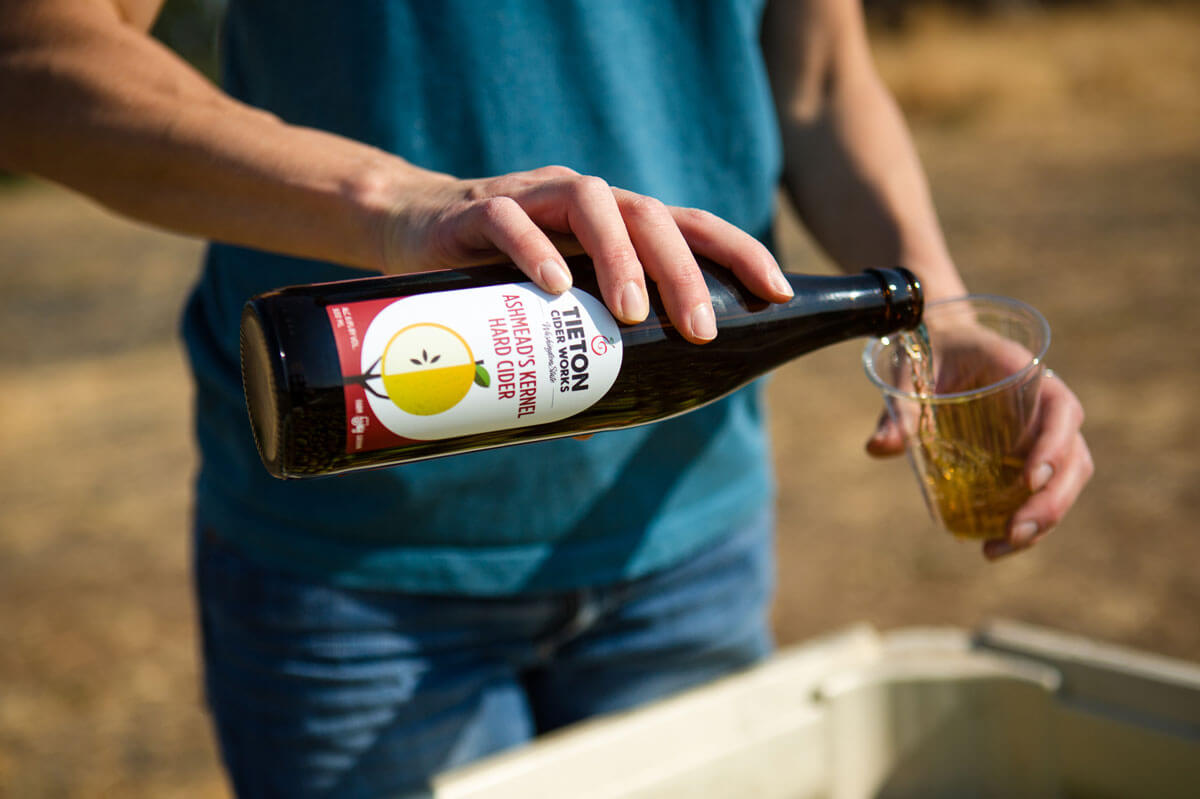 Orchard to Glass: Taste Washington Cider A man pours hard cider into a glass at Tieton Cider Works