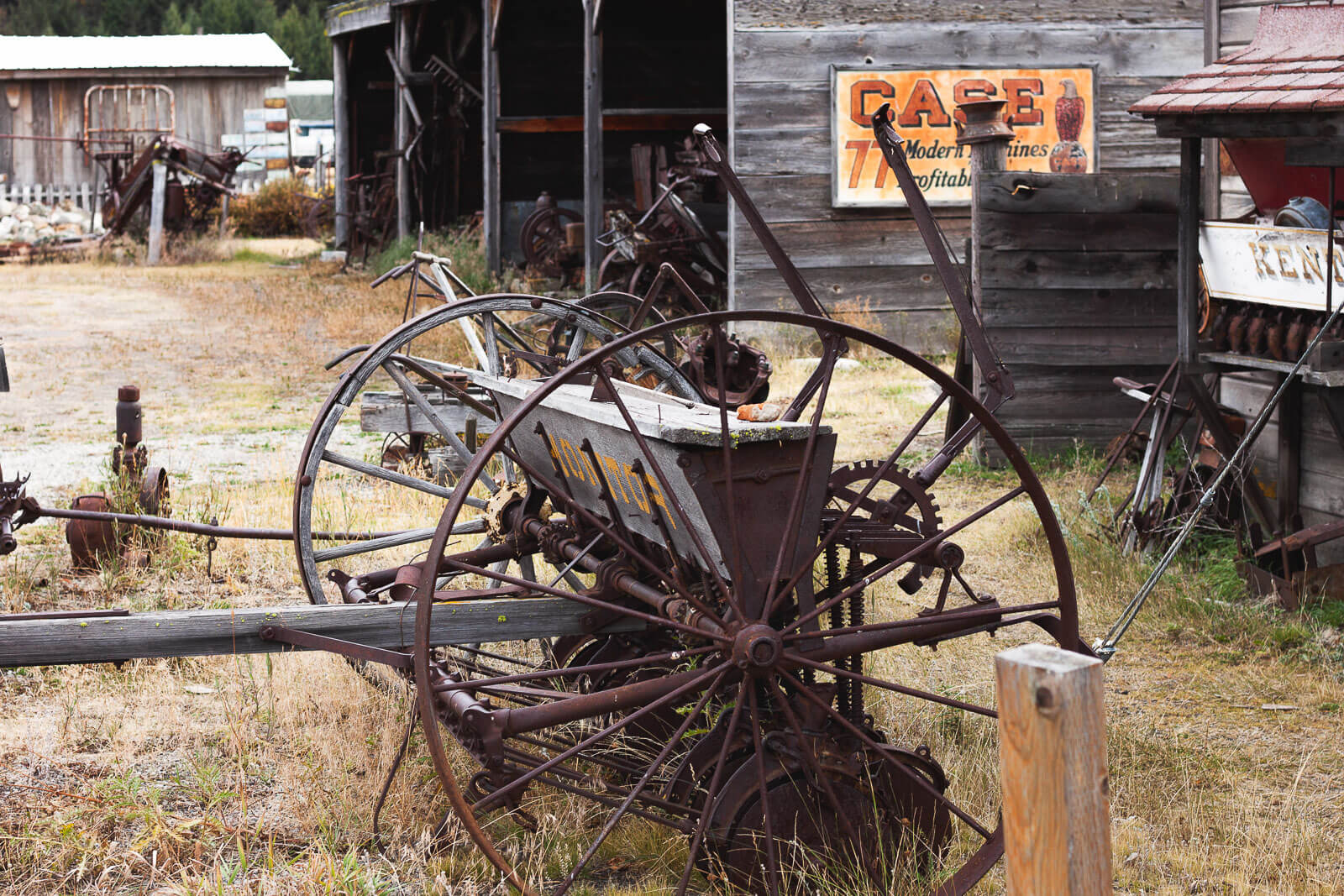 Discover Washington Ghost Towns Old farming equipment stands in tall grass in the Washington ghost town of Molson