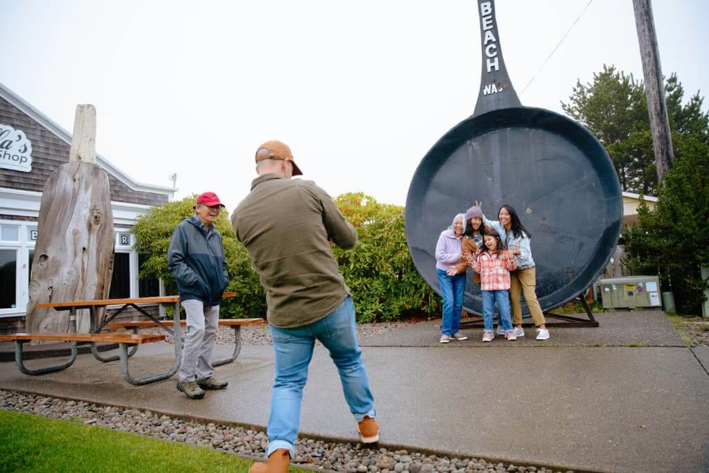 A family takes a photo in Long Beach, WA.